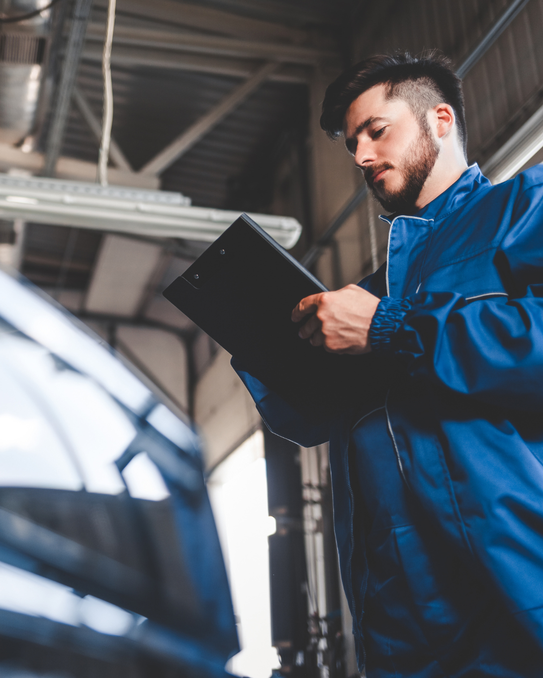 Mechanic checking fluids during seasonal maintenance in NJ